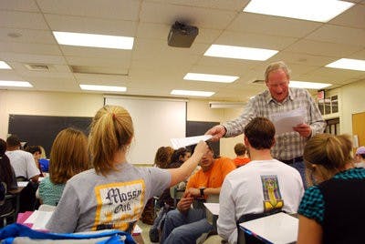 Professor Daryl Kuhlers returns quizzes to students in his Animal Breeding class. The class uses genetics and statistics to examine animals' breeding value and genetic improvement. (Tim Simpson / Photo Staff)
