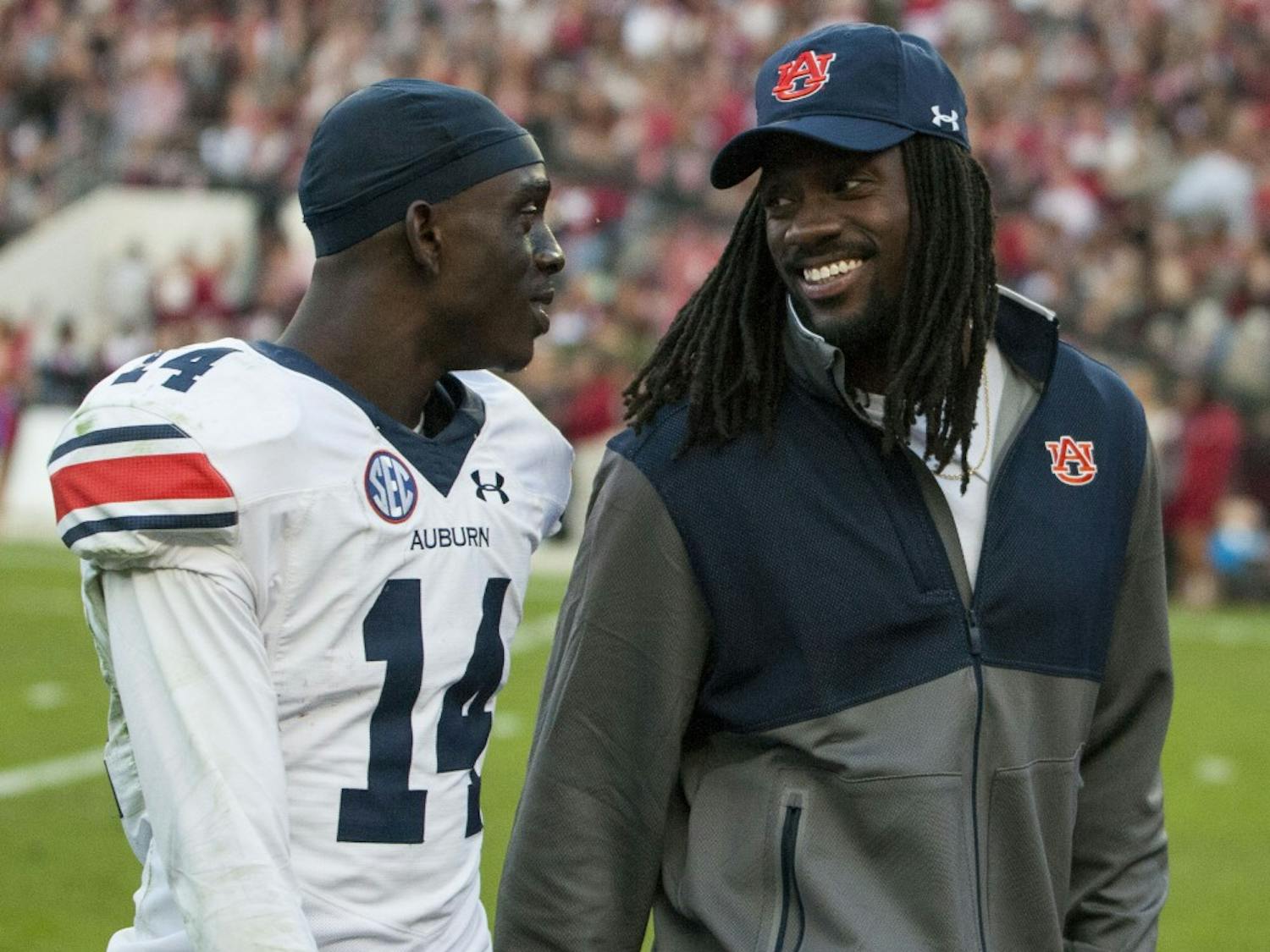 Former Auburn player Sammie Coates (right) and Auburn safety Stephen Roberts (14) have a chat as the Tigers head to the locker room at halftime. Auburn vs Alabama on Saturday, Nov. 26 in Tuscaloosa, AL.