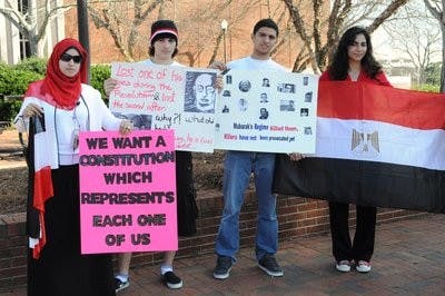 From left: Amira Roshdy, Maher Ismail, Basem Ismail and Farida Abou Zeida gather to show support on the one-year anniversary of the Egyptian Revolution. (Christen Harned / ASSISTANT PHOTO EDITOR)