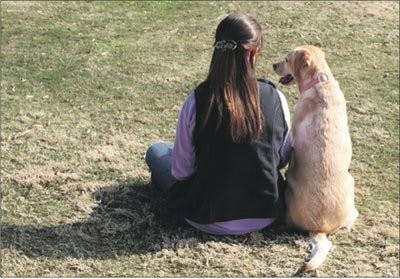 Sami Griffith and her four-year-old dog Gemini relax on the grass, enjoying the beautiful day. (Katherine McCahey / Assistant Photo Editor)