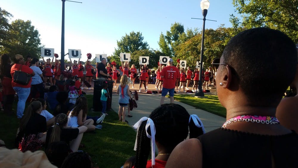 <p>Opelika High School cheerleaders lead a crowd of community members in a cheer Thursday, Aug. 29, 2019, in Opelika, Ala.&nbsp;</p>