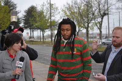 McNeil (center) walks into the Lee County Justice Center as reporters ask questions. (Raye May / PHOTO EDITOR)
