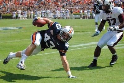 Philip Lutzenkirchen avoids a hit from ULM's Darius Prelow. (Maria Iampietro / Associate Photo Editor)
