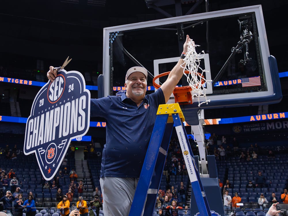 Bruce Pearl raises his freshly-cut net after winning the SEC Tournament on March 17, 2024
