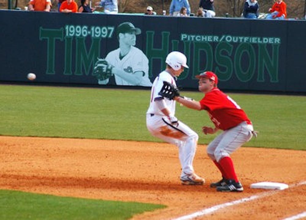 Junior Brian Fletcher rushes back to first base during a pickoff attempt. Emily Adams/ASSISTANT PHOTO EDITOR