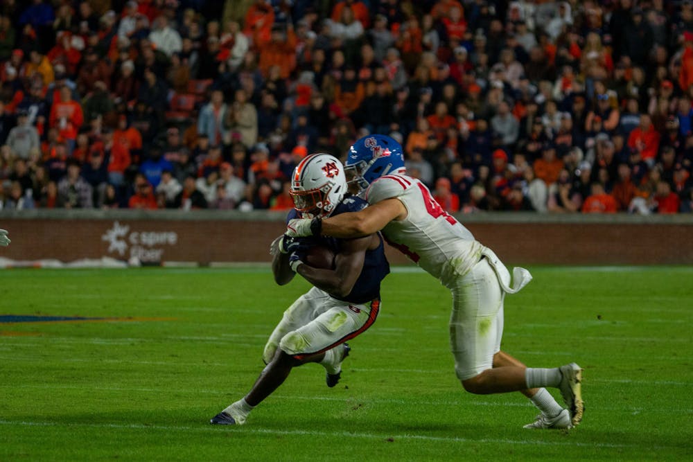 <p>Tank Bigsby (4) is wrapped up during a football game between Ole Miss and Auburn on Oct. 30, 2021, from Jordan-Hare Stadium in Auburn, AL, USA.</p>