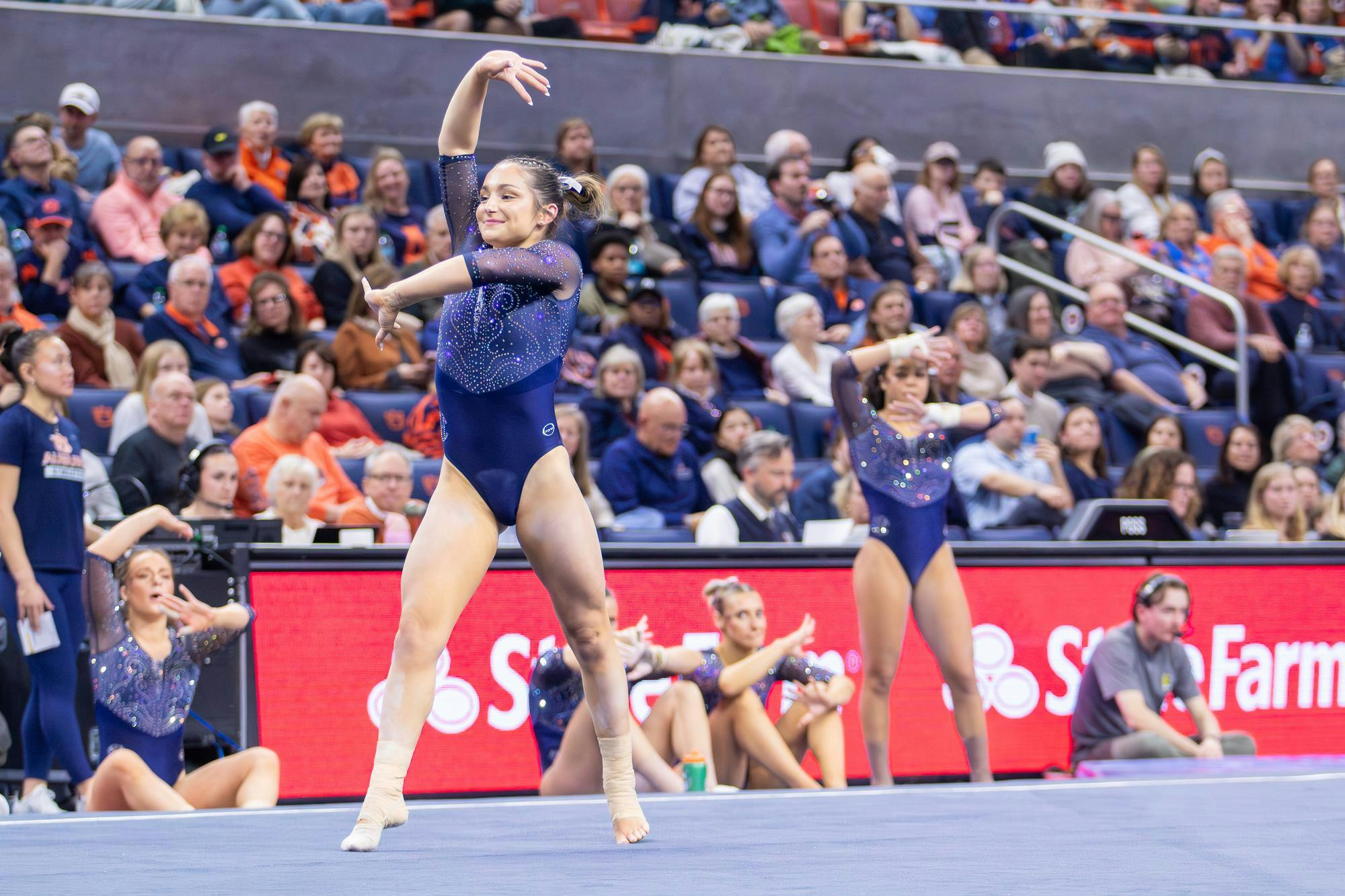 Bryn Bartman performs her floor routine with her teammates copying her in the background during the meet against Florida on Jan. 23, 2026 in Neville Arena in Auburn, Ala. 