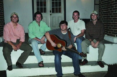 Left to right: Casey Chilson, David Chenault, Spencer Daniel, Troy Braswell and John Babington sit on the steps of the house where their band, Marv and the Stikky Bandits, practices. The band, which covers popular songs, will be performing Feb. 2 at Bourbon Street Bar. (Christen Harned / ASSISTANT PHOTO EDITOR)