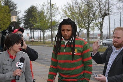 McNeil (center) walks into the Lee County Justice Center as reporters ask questions. (Raye May / PHOTO EDITOR)