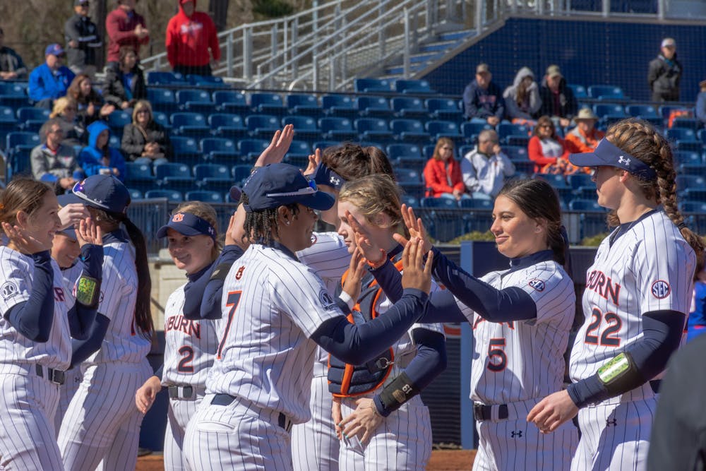 <p>Feb. 13, 2022; Auburn, Ala; The Auburn softball team celebrates after a 8-0 victory over UMass Lowell in the Tiger Invitational from Jane B. Moore Field.</p>