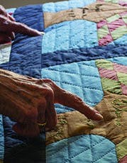 Morningside resident Bein shows off her family tree, woven into a quilt.