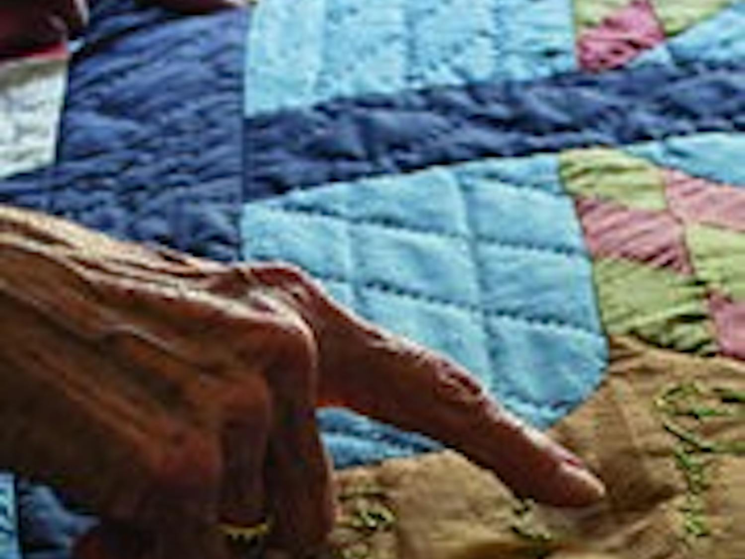 Morningside resident Bein shows off her family tree, woven into a quilt.