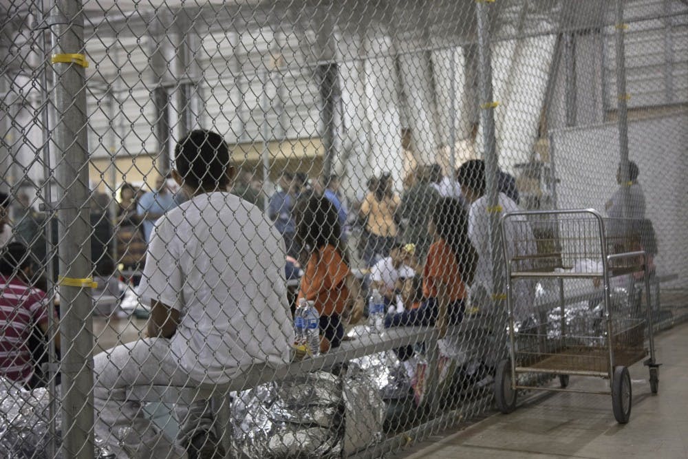 In this photo provided by U.S. Customs and Border Protection, people who've been taken into custody related to cases of illegal entry into the United States, sit in one of the cages at a facility in McAllen, Texas, on June 17, 2018. (U.S. Customs and Border Protection's Rio Grande Valley Sector/TNS)