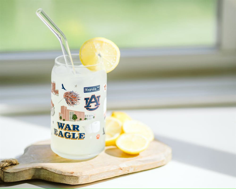 <p>A glass of lemonade sits on a table.</p>