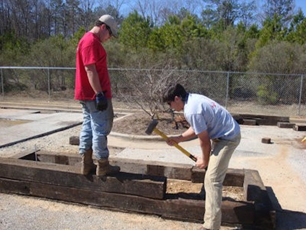 Elliott Miller and Barkley Mallette, CEBE students, work together to build a planter for EAMHC's upcoming green space. (Contributed)