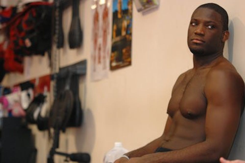 Auburn MMA fighter Malcolm Hardmon takes a break from training to drink his required two gallons of water for the day. Hardmon will compete for a state title Saturday. (Rebekah Weaver / Assistant Photo Editor)