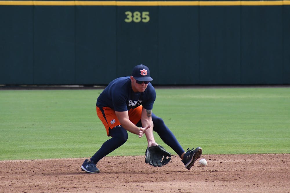 Infielder Cooper Weiss fields a ground ball at Auburn baseball practice.