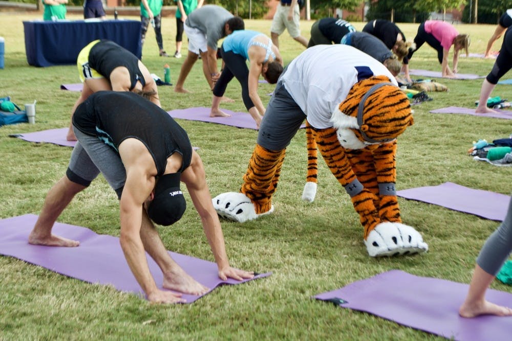<p>Aubie helps demonstrate a pose during a free yoga class held on the campus green, on&nbsp;Tuesday, Sept. 28, 2021 in Auburn, Ala.</p>