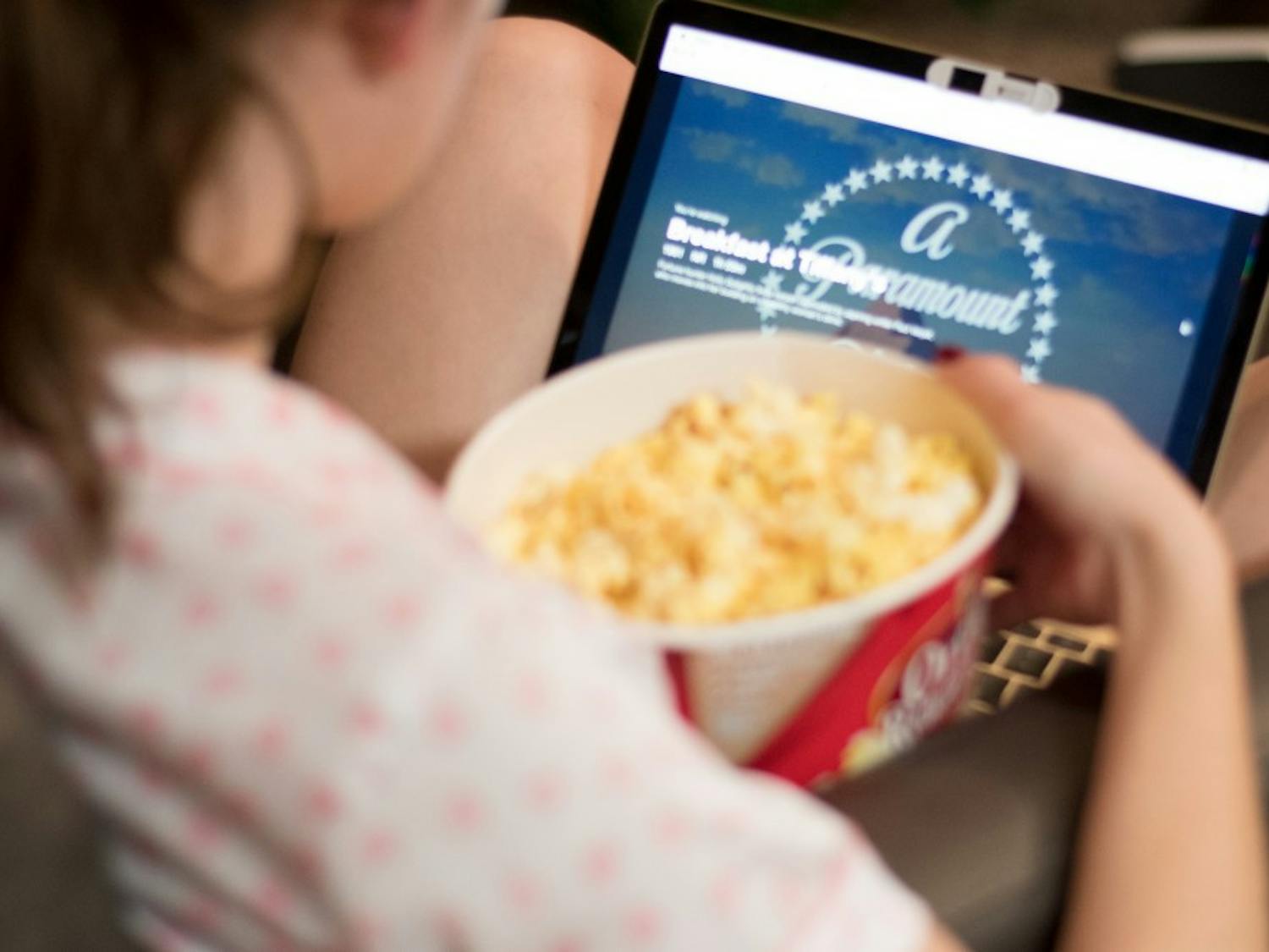 A student watches a movie on Netflix with a bowl of popcorn on Monday, Feb. 5, 2018, in Auburn, Ala.