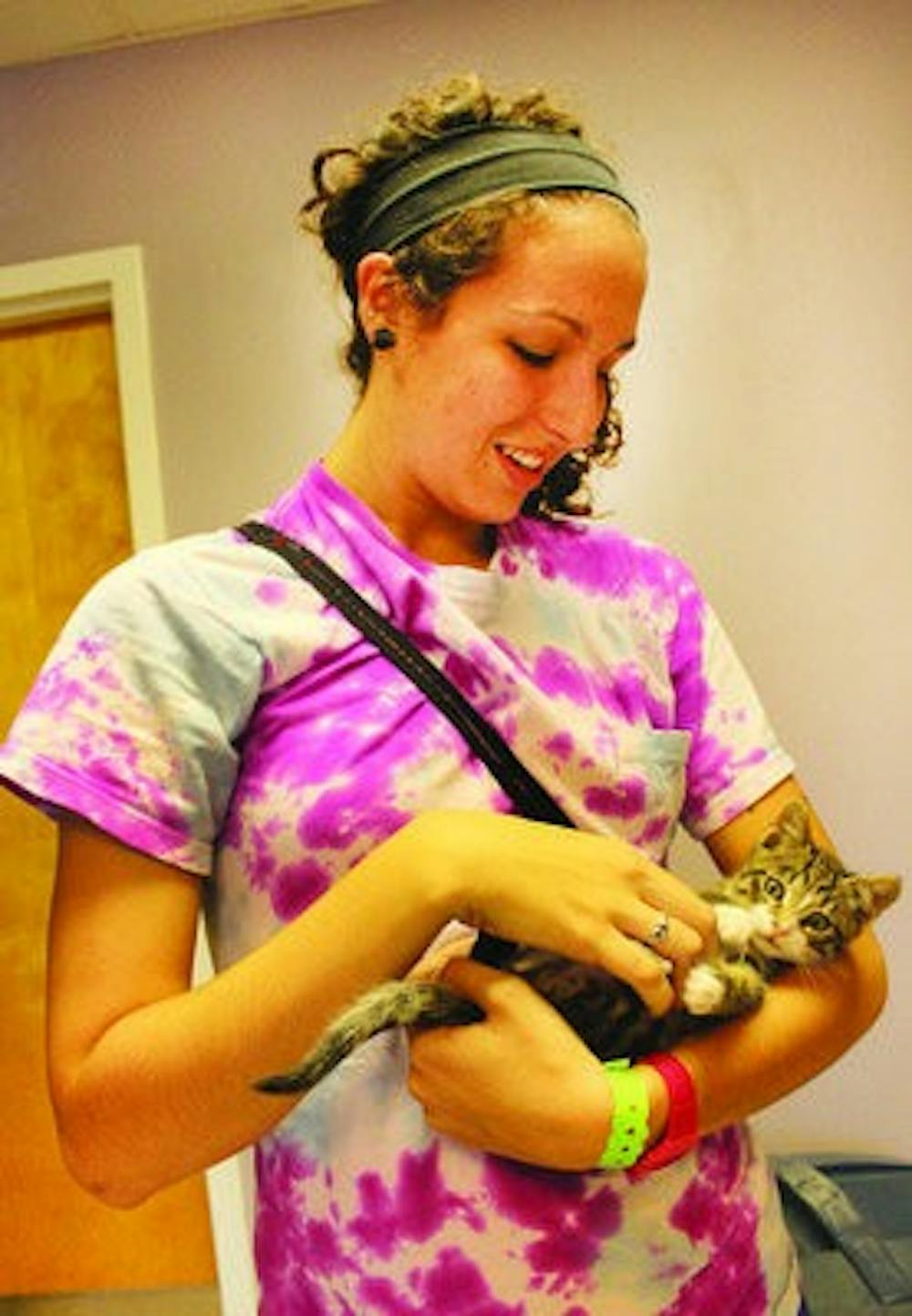 Sophomore Sarah Allen cradles a kitten at the LCHS. Cat adoptions are free and kitten adoptions are discounted through the end of November. (Alex Sager / ASSOCIATE PHOTO EDITOR)