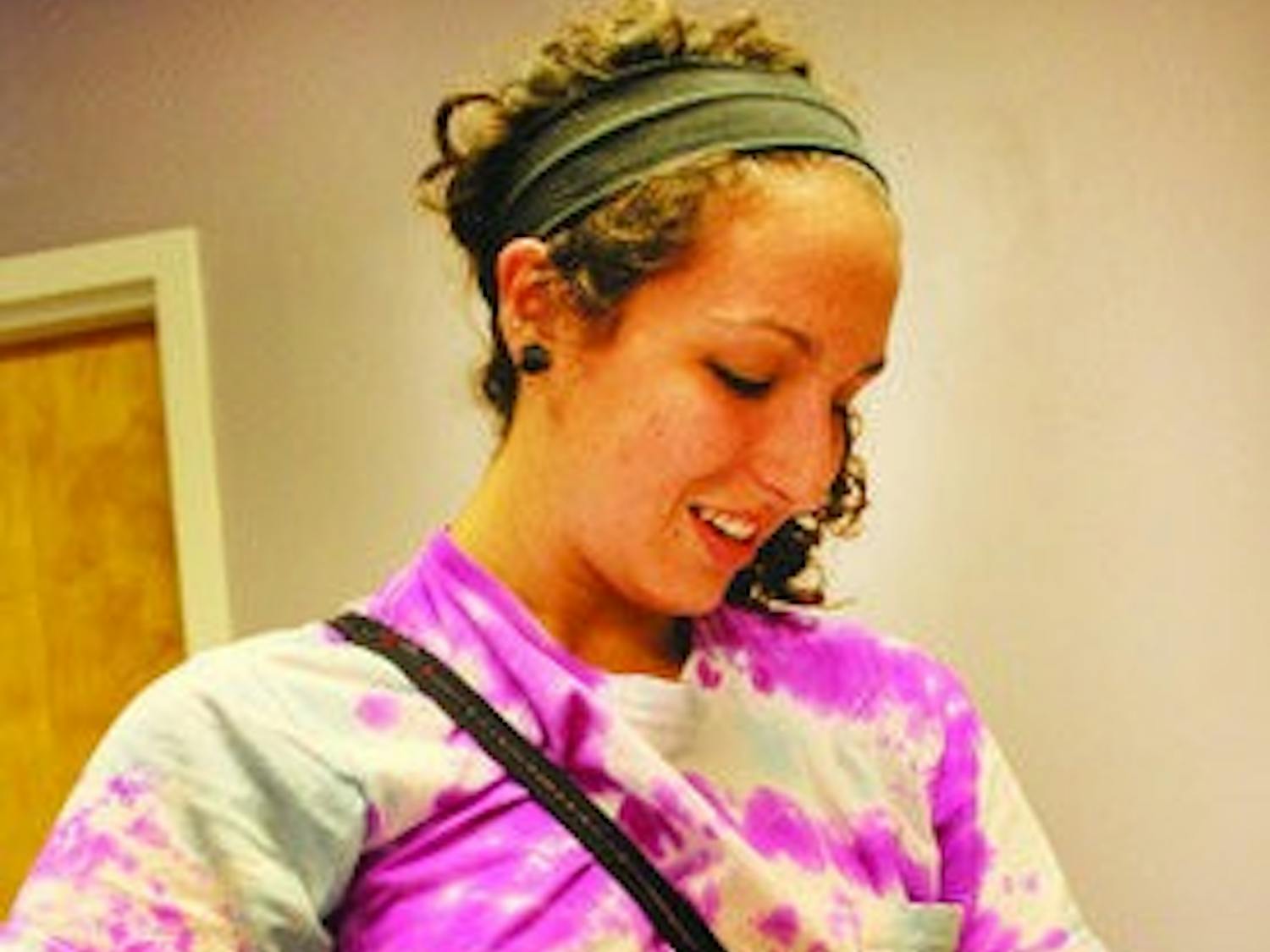 Sophomore Sarah Allen cradles a kitten at the LCHS. Cat adoptions are free and kitten adoptions are discounted through the end of November. (Alex Sager / ASSOCIATE PHOTO EDITOR)