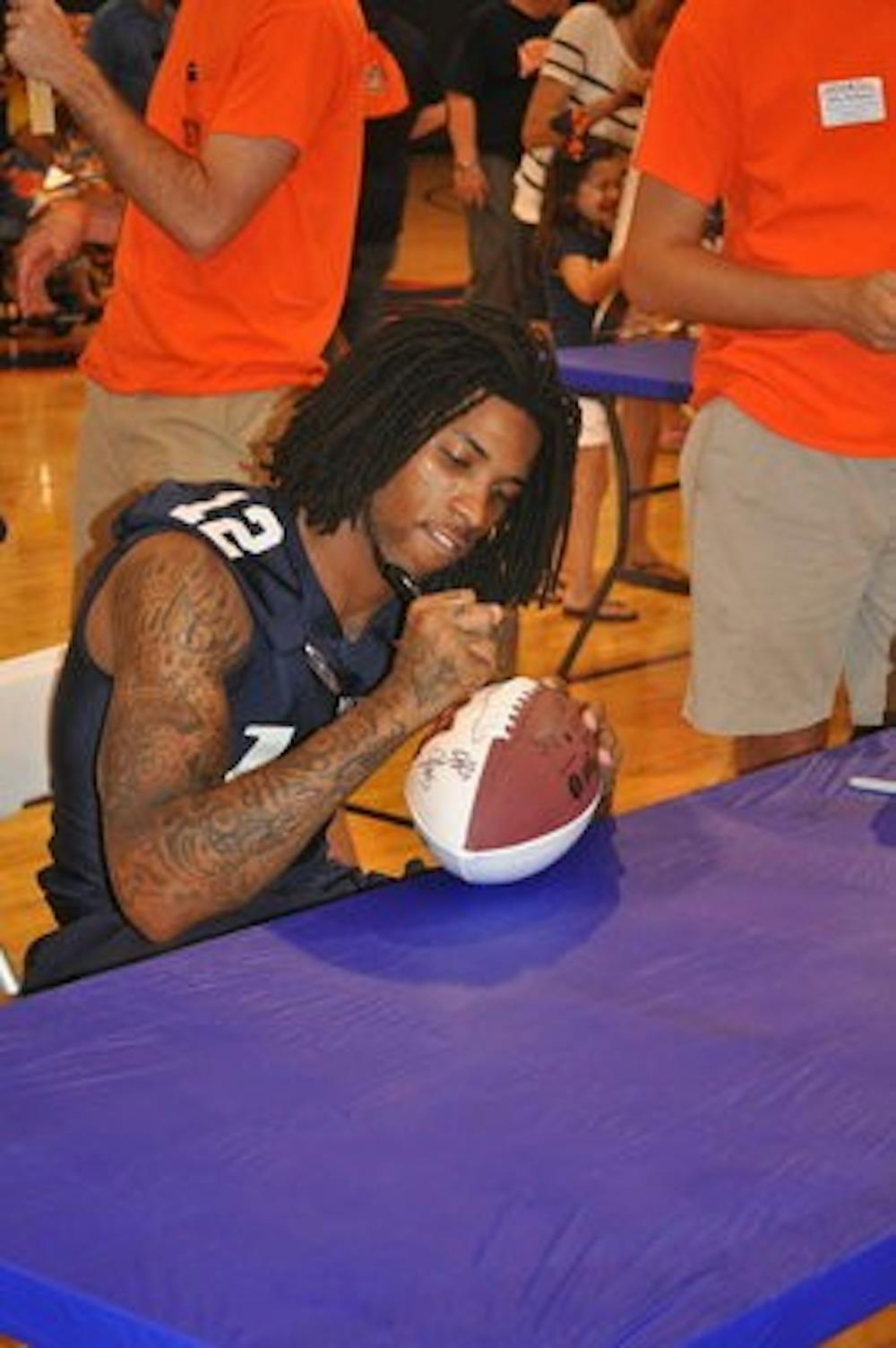 Demetruce McNeal signing autographs at fan day