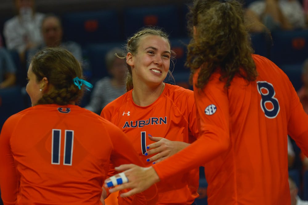 <p>Madison Scheer (#1) celebrates a point with teammates in a match between Auburn and Alabama A&amp;M at Neville Arena on Sep. 6, 2022.</p>