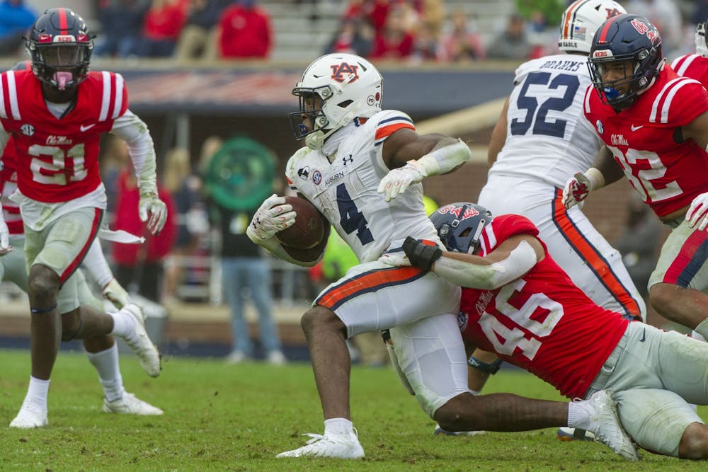 <p>Mississippi Rebels linebacker MoMo Sanogo (46) tackles Auburn Tigers running back Tank Bigsby (4) during the second half at Vaught-Hemingway Stadium on Oct 24, 2020; Oxford, Mississippi, USA. Photo via: Justin Ford-USA TODAY Sports</p>
