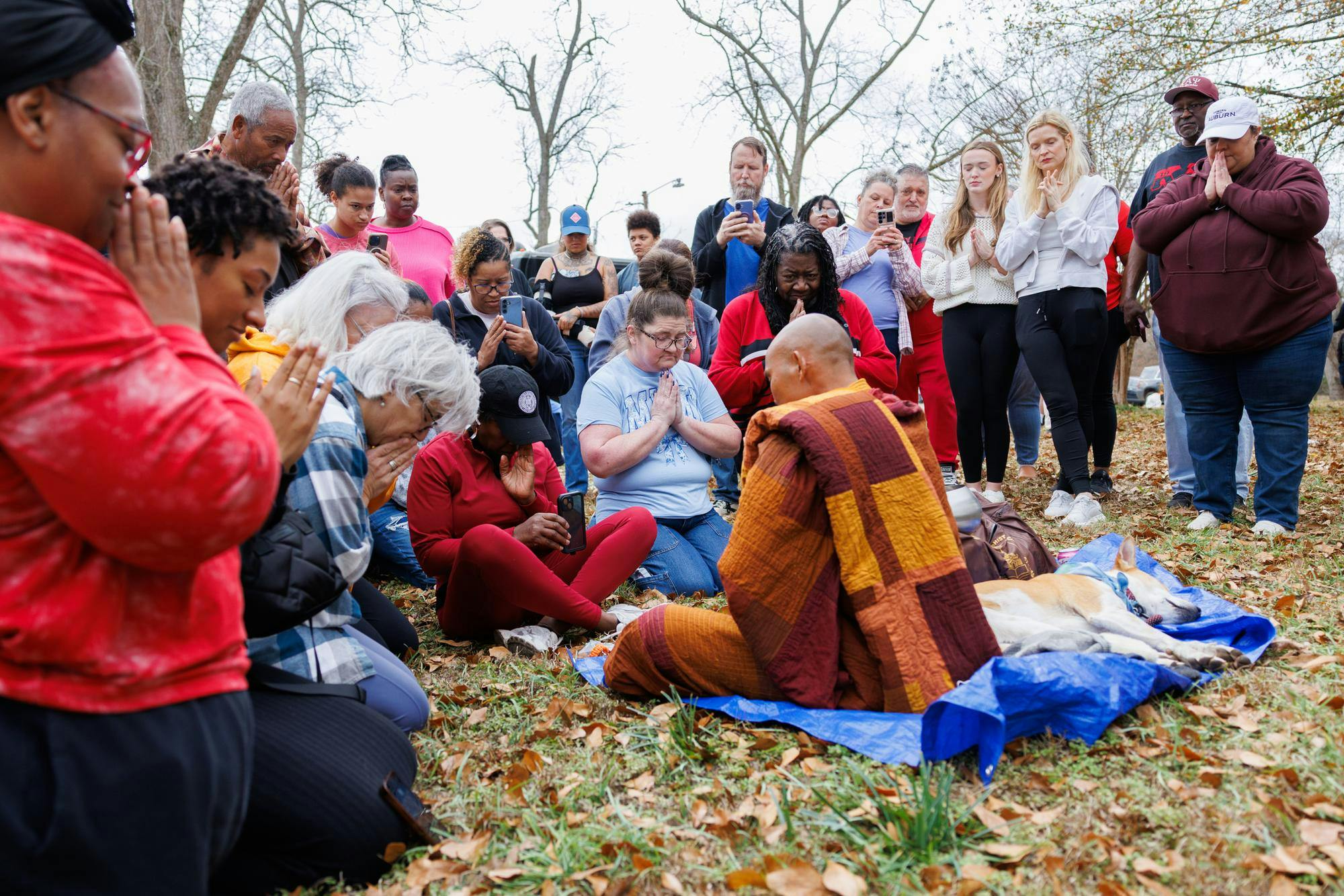Venerable Monk Bhikkhu Pannakara leads a moment of quiet, mindful presence during a lunch stop in Cusseta, Ala. after walking from Opelika on Dec. 26, 2025.