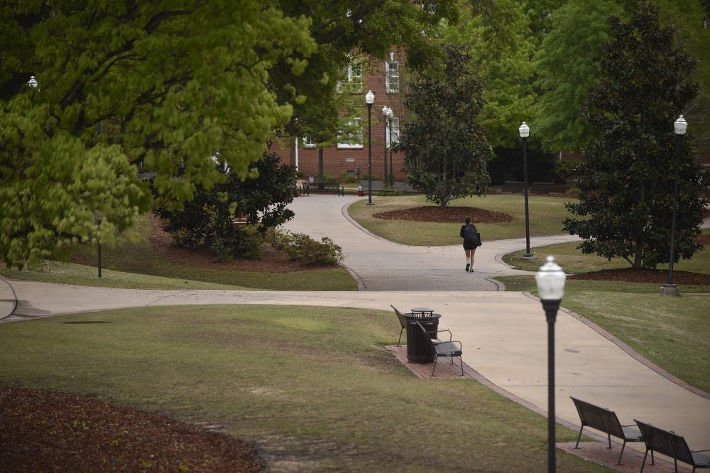 <p>A student walks down an empty sidewalk on Auburn University's campus at 3 p.m., Wednesday, April 4, 2017, in Auburn, Ala. Classes have been cancelled for the day due to severe weather and tornado watches.</p>