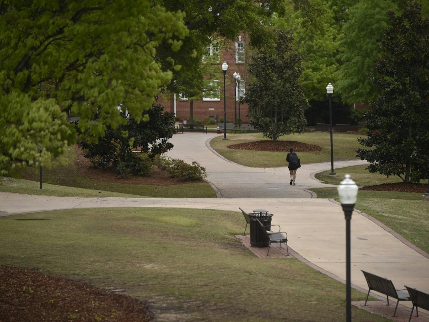 A student walks down an empty sidewalk on Auburn University's campus at 3 p.m., Wednesday, April 4, 2017, in Auburn, Ala. Classes have been cancelled for the day due to severe weather and tornado watches.