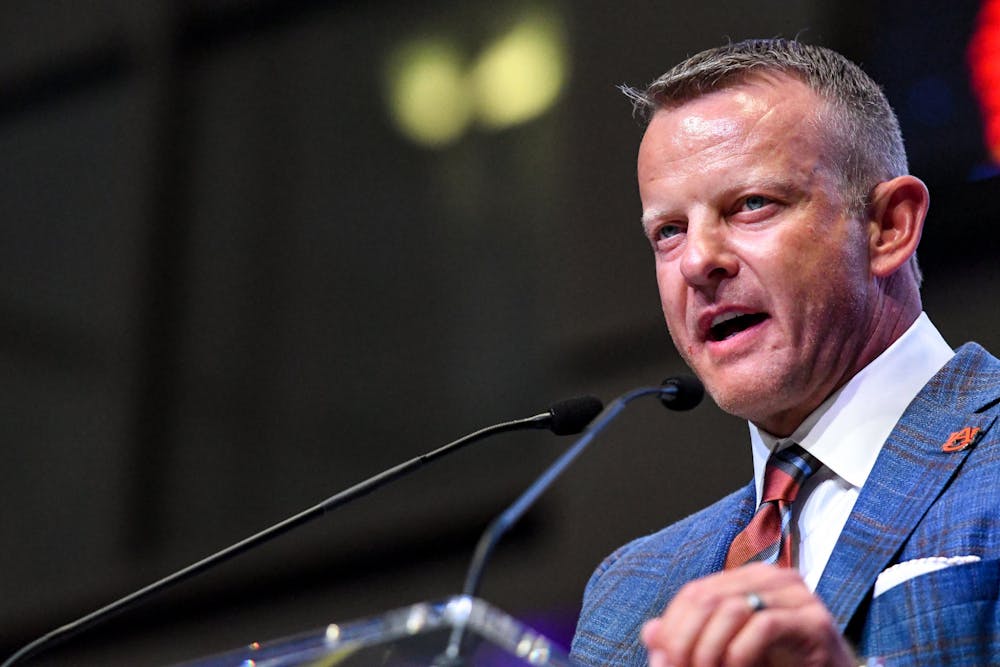 July 21, 2022; Atlanta, Georgia, USA; Auburn head coach Bryan Harsin speaks to a crowd of reporters during SEC Media Day at the College Football Hall of Fame.