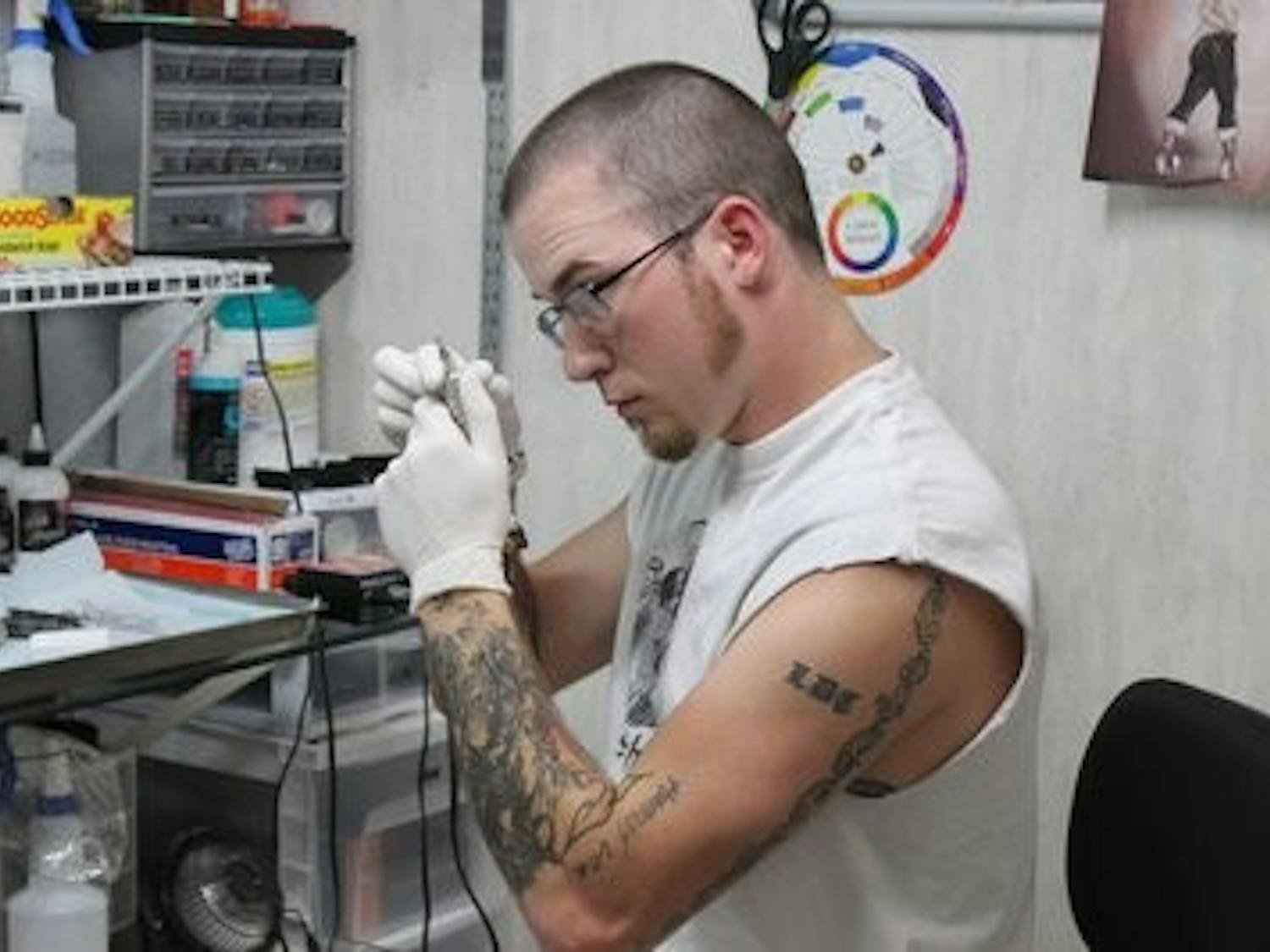 Colin Thrift, tattoo artist at Voodoo Needle, prepares a needle. (Alex Sager / Photo Editor)