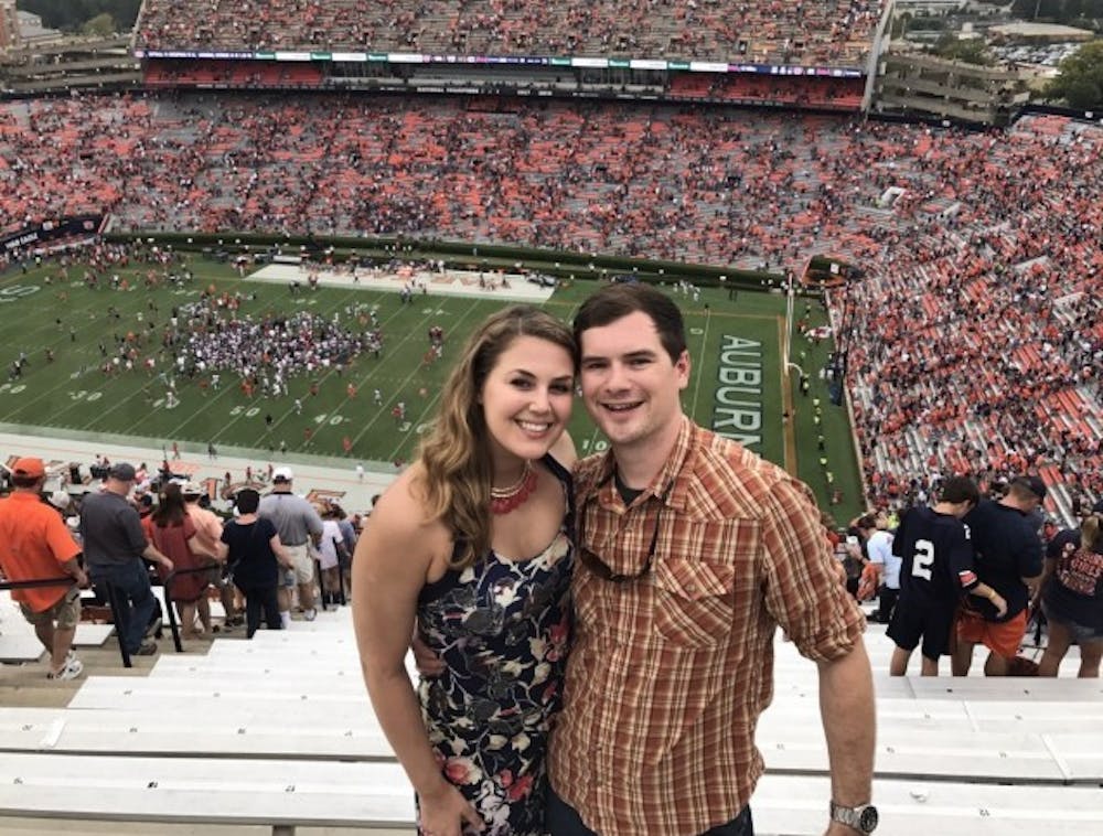 <p>Sophie Roth and Frank Pierce pose at a football game in Jordan-Hare Stadium.</p>