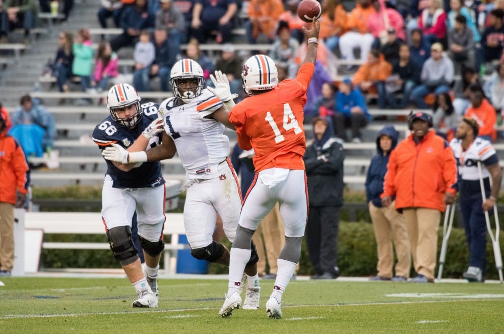 Malik Willis (14) passes under pressure from Big Kat Bryant (1)&nbsp;during Auburn's A-Day game on Saturday, April 7, 2018, in Auburn, Ala.