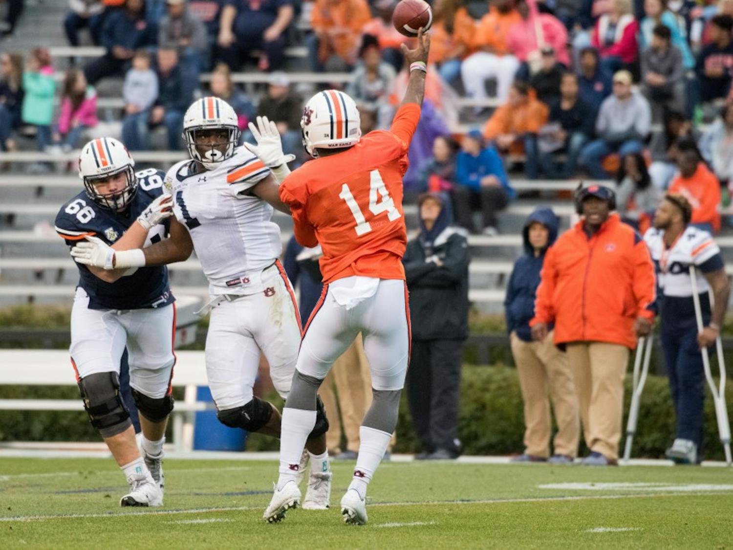 Malik Willis (14) passes under pressure from Big Kat Bryant (1) during Auburn's A-Day game on Saturday, April 7, 2018, in Auburn, Ala.