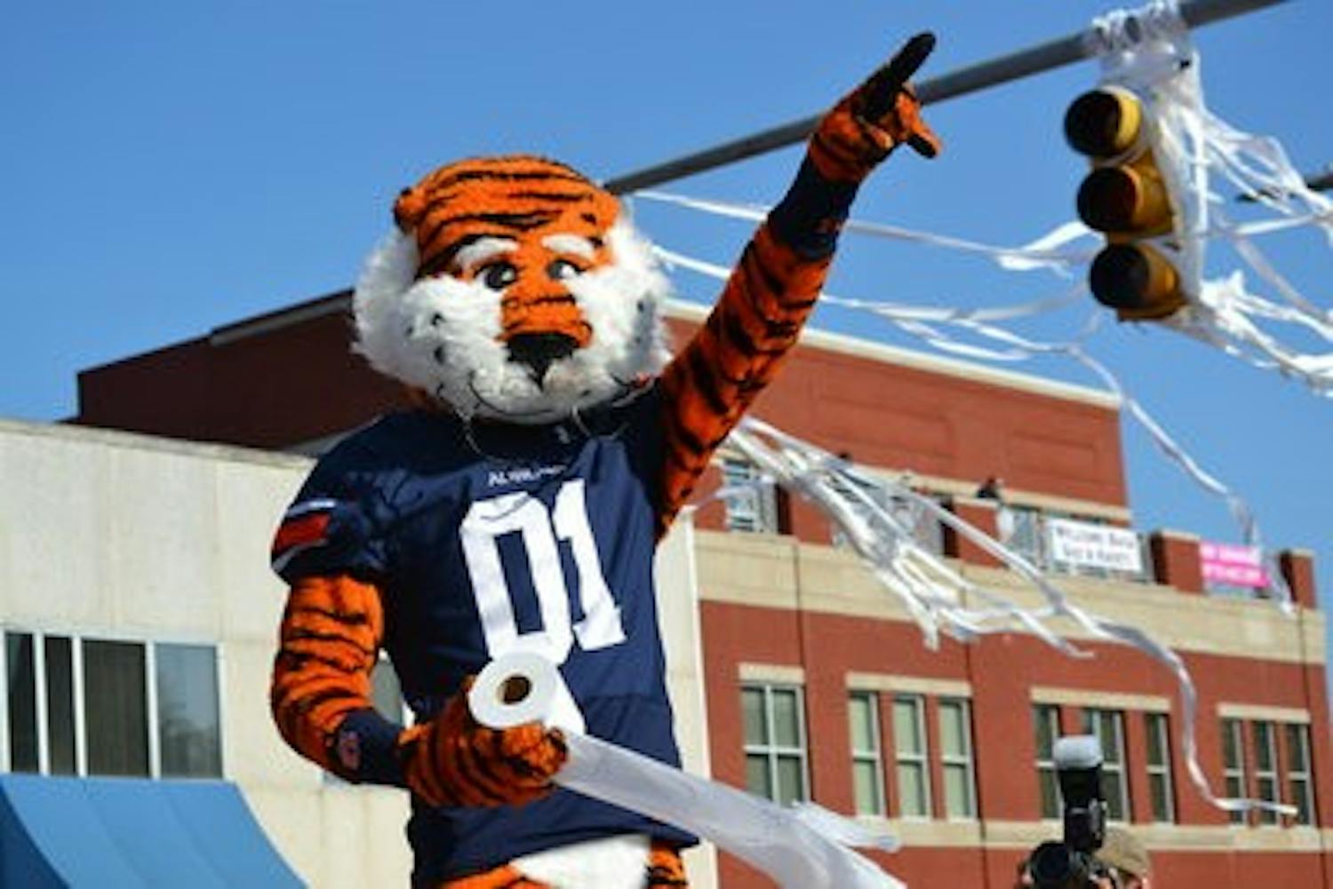 Aubie prepares to throw a roll of toilet paper at the oak trees.
(Raye May / PHOTO EDITOR)