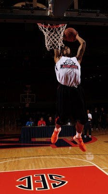Sophomore guard Chris Denson dunks during the dunk contest. (Todd Van Emst)