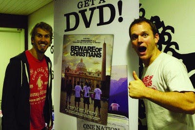 Will Bakke, left, and Alexander Carroll pose in front of their film's poster in Dudley Hall. (Rebecca Croomes / ASSISTANT PHOTO EDITOR)
