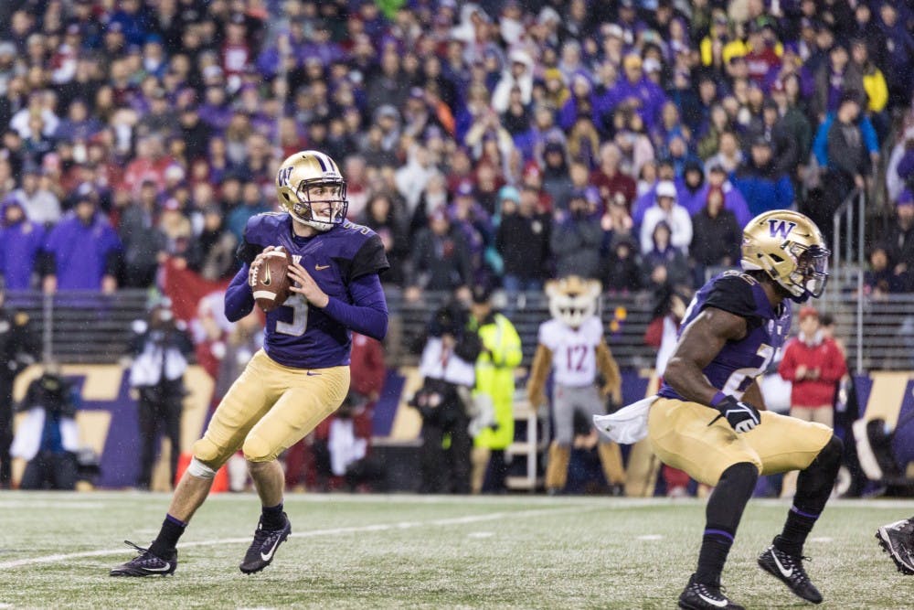 <p>Quarterback Jake Browning searches for the pass during the Apple Cup. Photo courtesy of the UW Daily sports desk.&nbsp;</p>