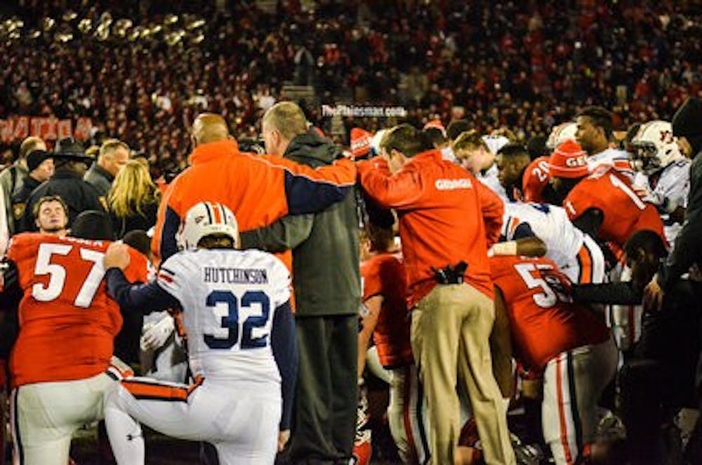 Auburn and Georgia players joined in the middle of the field for a post-game prayer. Raye May / PHOTO EDITOR