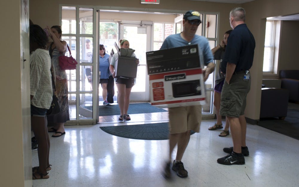 <p>Parents assist students move into The Hill dorms on Thursday, August 13.</p>