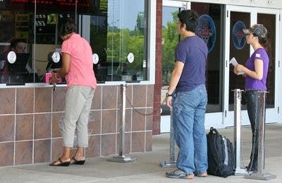 Moviegoers wait in line to purchase tickets at Carmike Cinemas. (Alex Sager / PHOTO EDITOR)