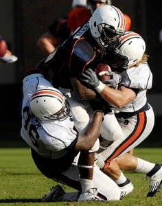Freshman running back Jovon Robinson (middle) was released from his scholarship after it was revealed his transcript was altered by his high school counselor. (Courtesy of Todd Van Emst)