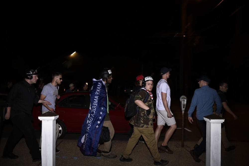 Alt-right protesters move along South Gay Street following alt-right leader Richard Spencer's talk on Tuesday, April 18, 2017 in Auburn, Ala. 