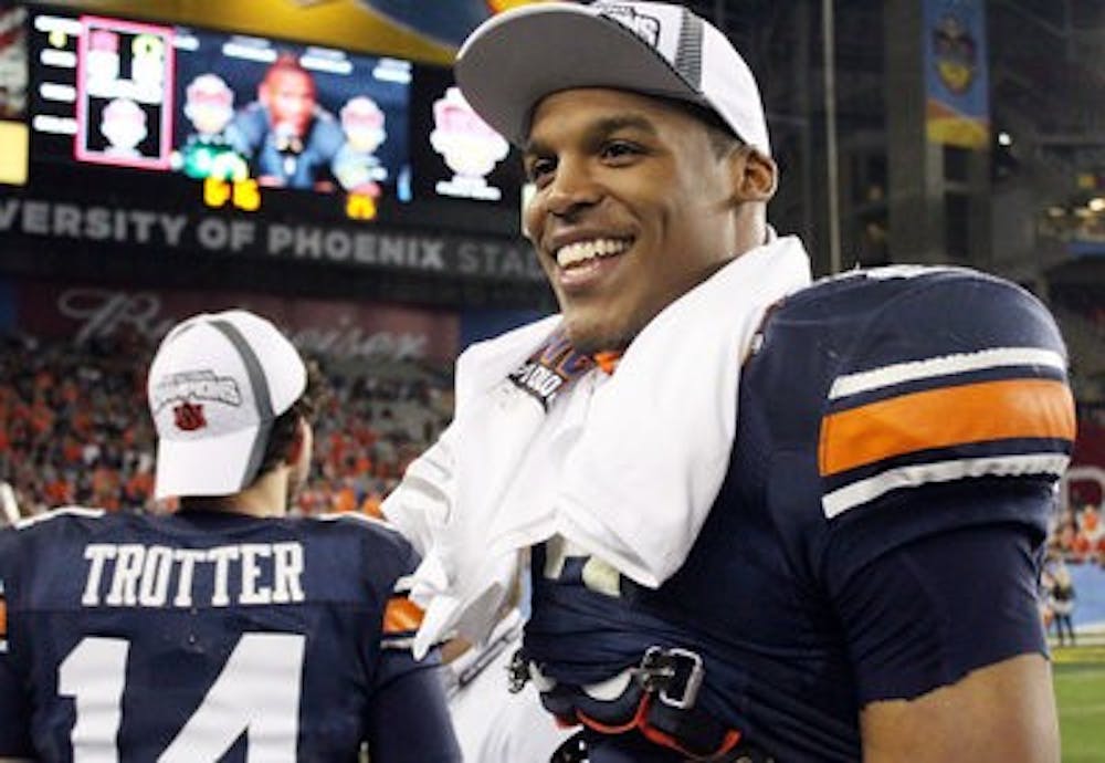 <p>Cam Newton smiles as he celebrates the Auburn victory. (File photo)</p>