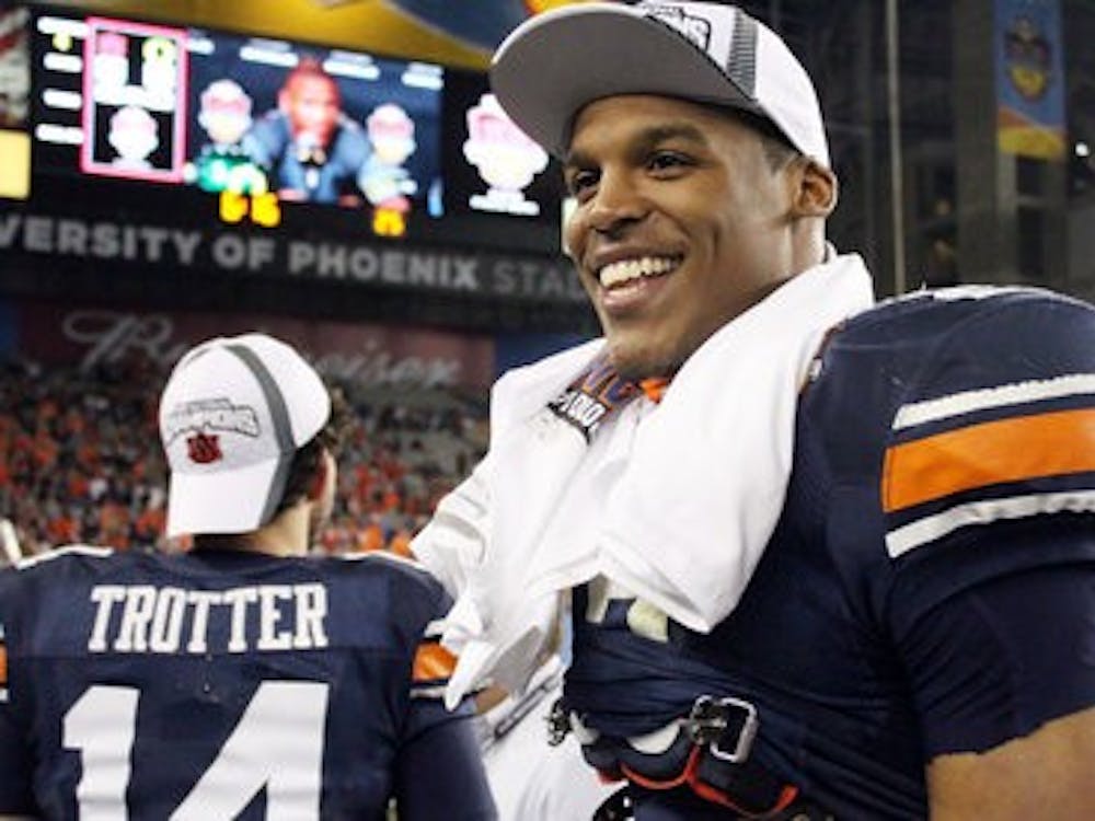 Cam Newton smiles as he celebrates the Auburn victory. (File photo)