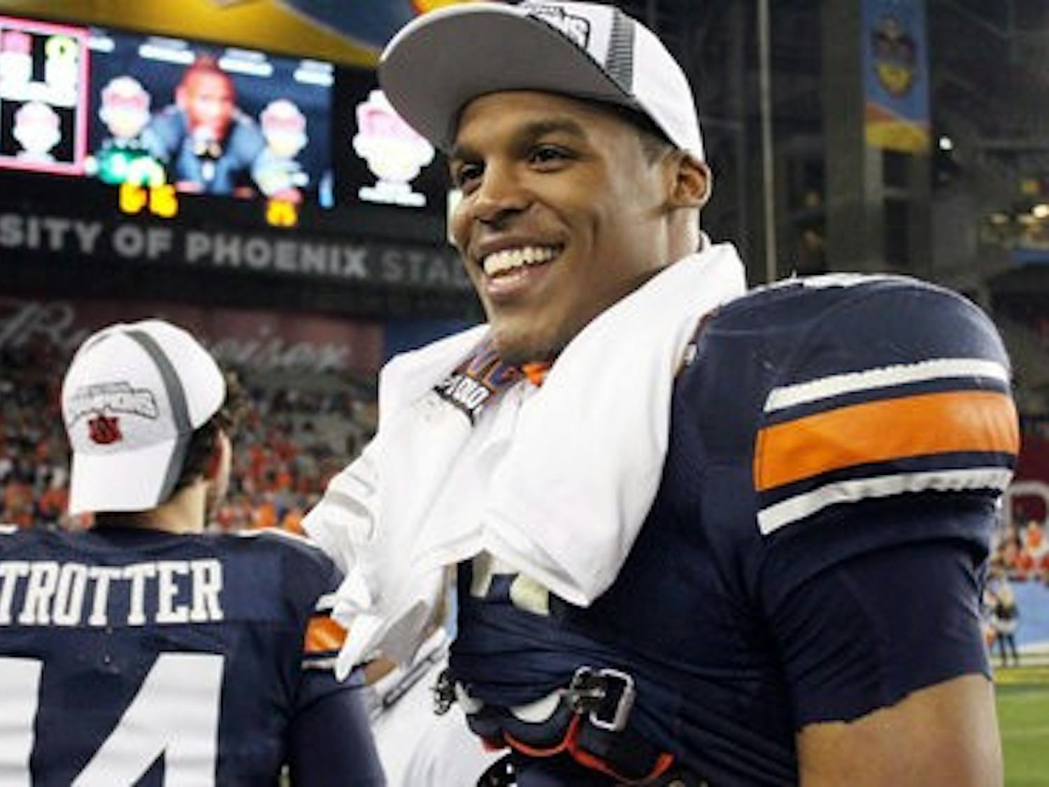 Cam Newton smiles as he celebrates the Auburn victory. (File photo)