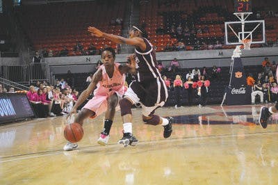Sophomore guard Morgan Toles keeps the ball away from a Mississippi State player during Sunday's game. (Christen Harned / Assistant Photo Editor)