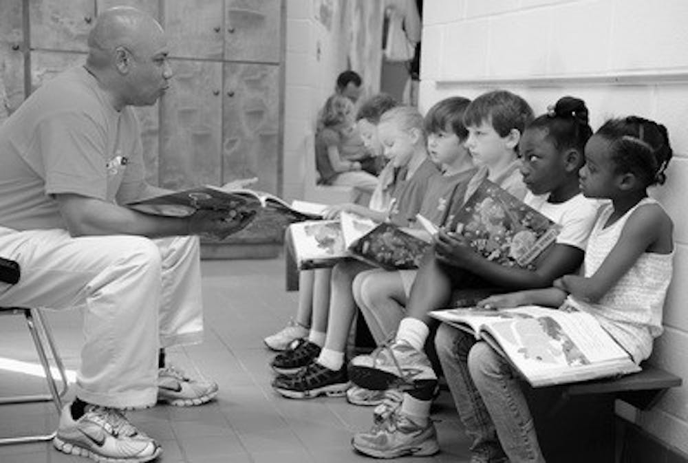 Auburn track coach Ralph Spry reads to kids at Dean Road Elementary school in Auburn.Auburn staff during Tigers Give Back day on Monday, April 27, 2009 in Auburn, Ala.Todd Van Emst